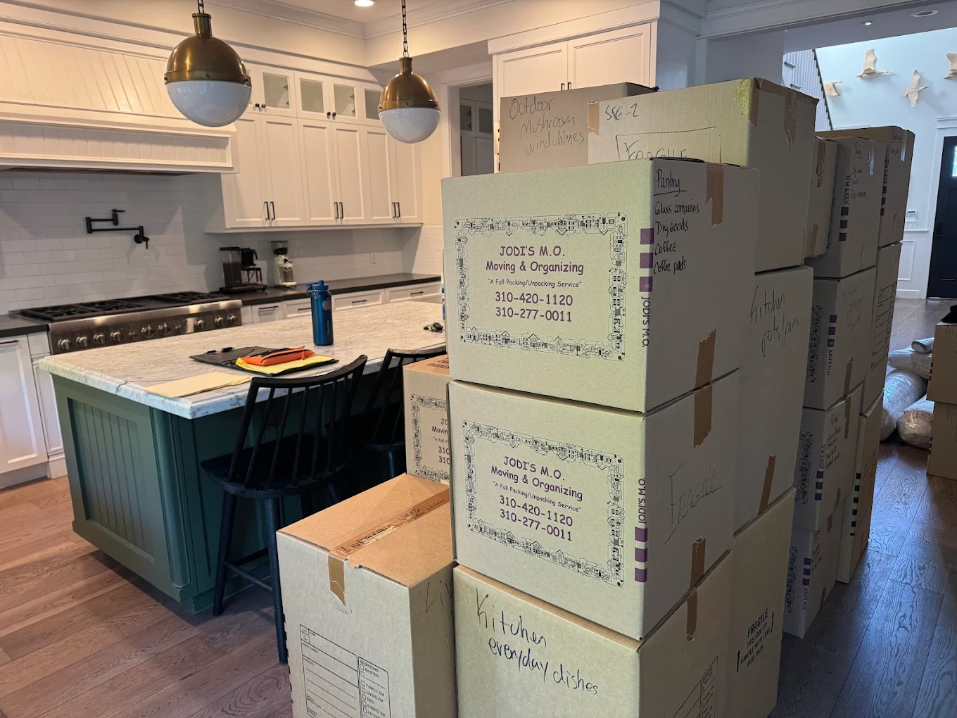 Carefully labeled Jodi's M.O. boxes stacked in a client's kitchen
